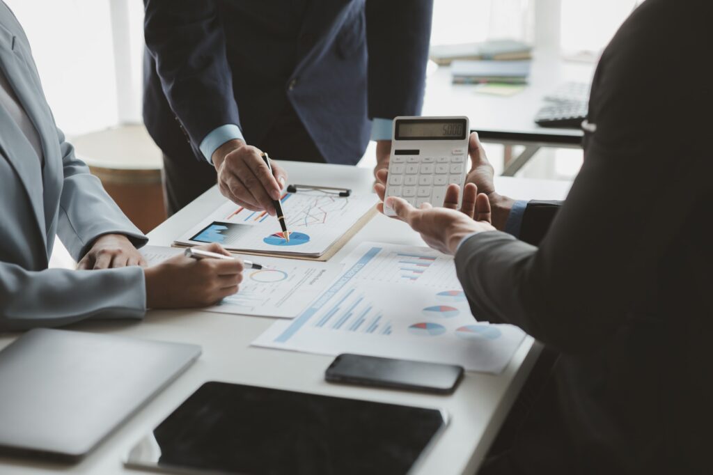 Businessman is reviewing monthly sales documents for analysis and marketing plans for more sales gro